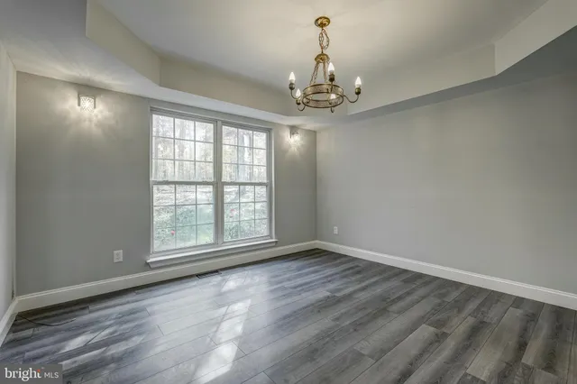a view of a hallway with wooden floor and entryway