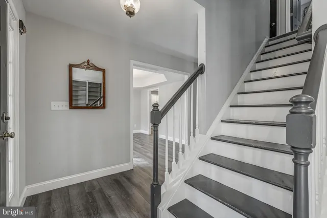 a view of entryway with wooden floor and stairs
