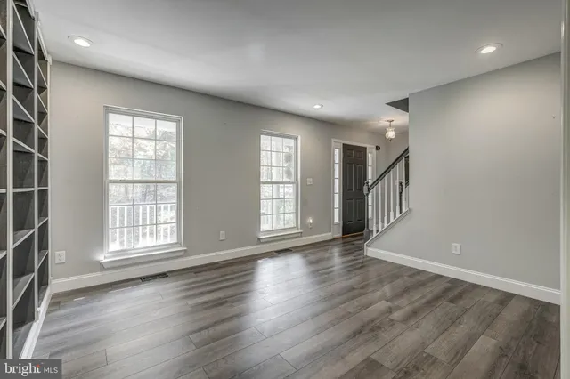 a view of an empty room with a fireplace and a window