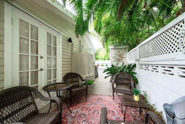 1218 Packer Street, Unit REAR Key West, FL 33040 - Photo 18 of 22 a backyard of a house with table and chairs