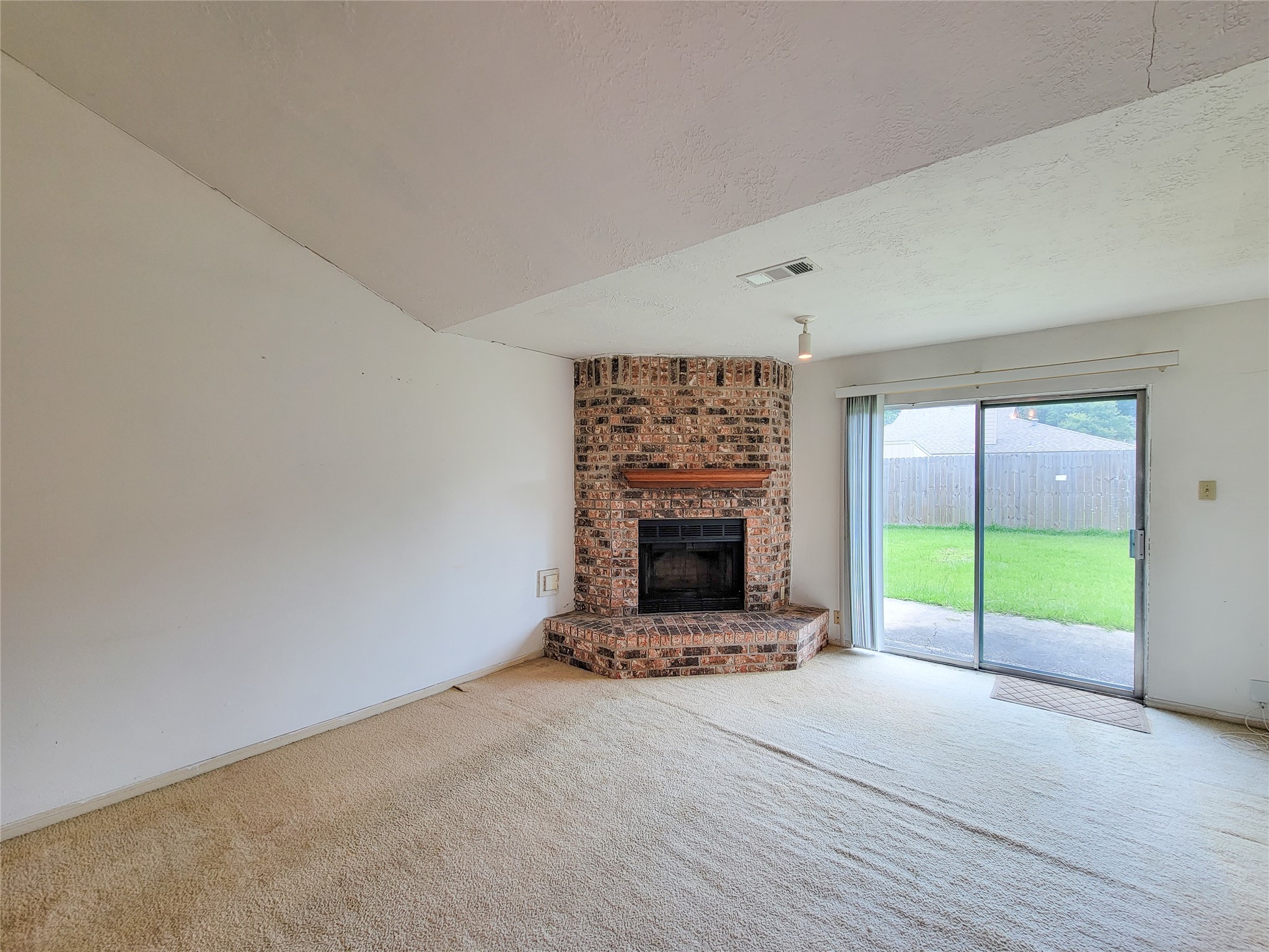 23211 Timberbrook Drive Spring, TX 77373 - Photo 7 of 34 a view of an empty room with a fireplace and a window