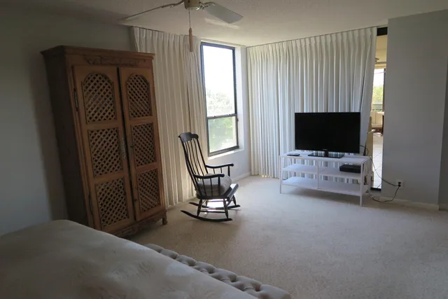 a view of a livingroom with furniture and a flat screen tv