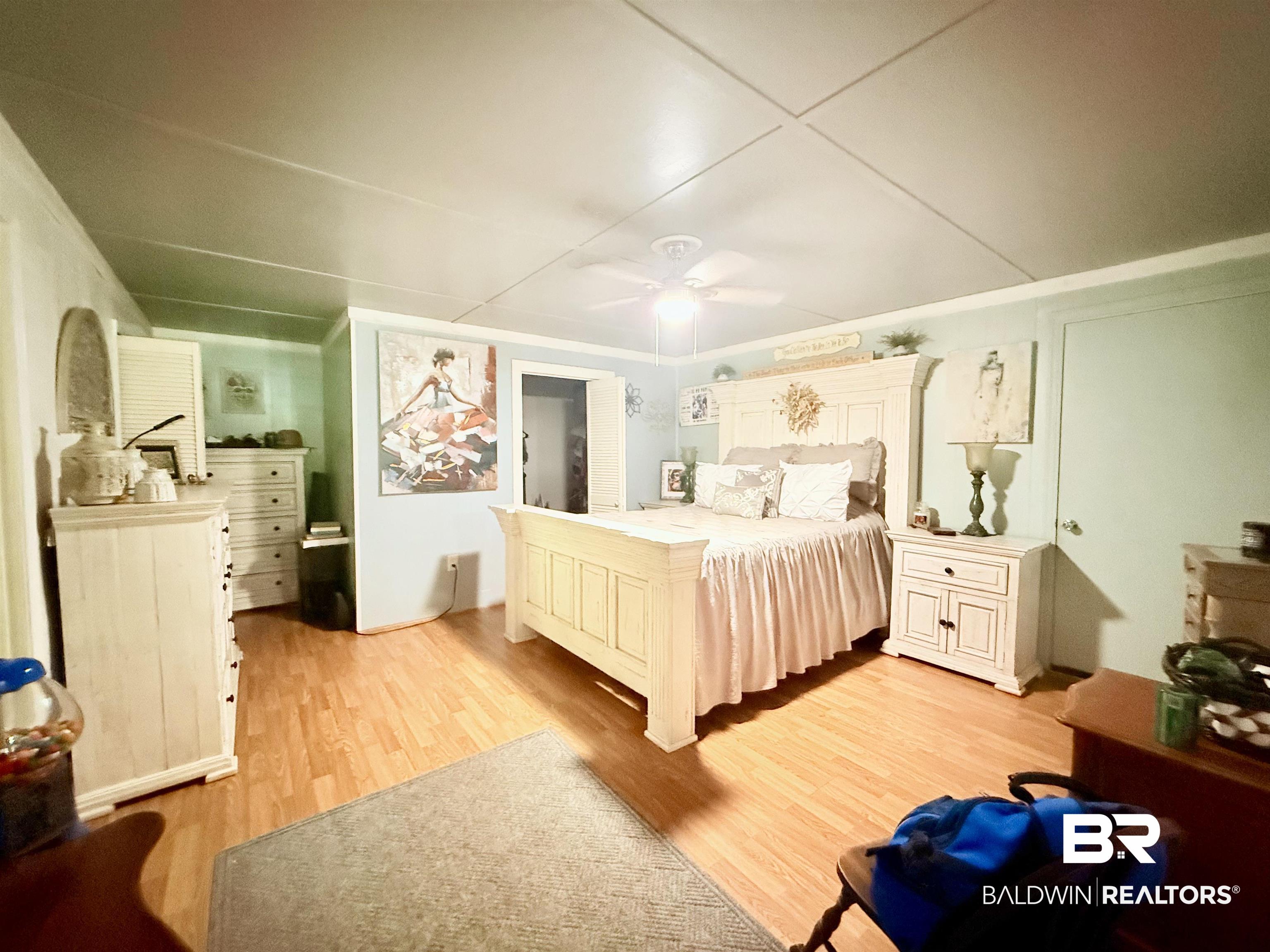 21305 River Road Robertsdale, AL 36567 - Photo 9 of 50 Bedroom with light wood finished floors and ceiling fan