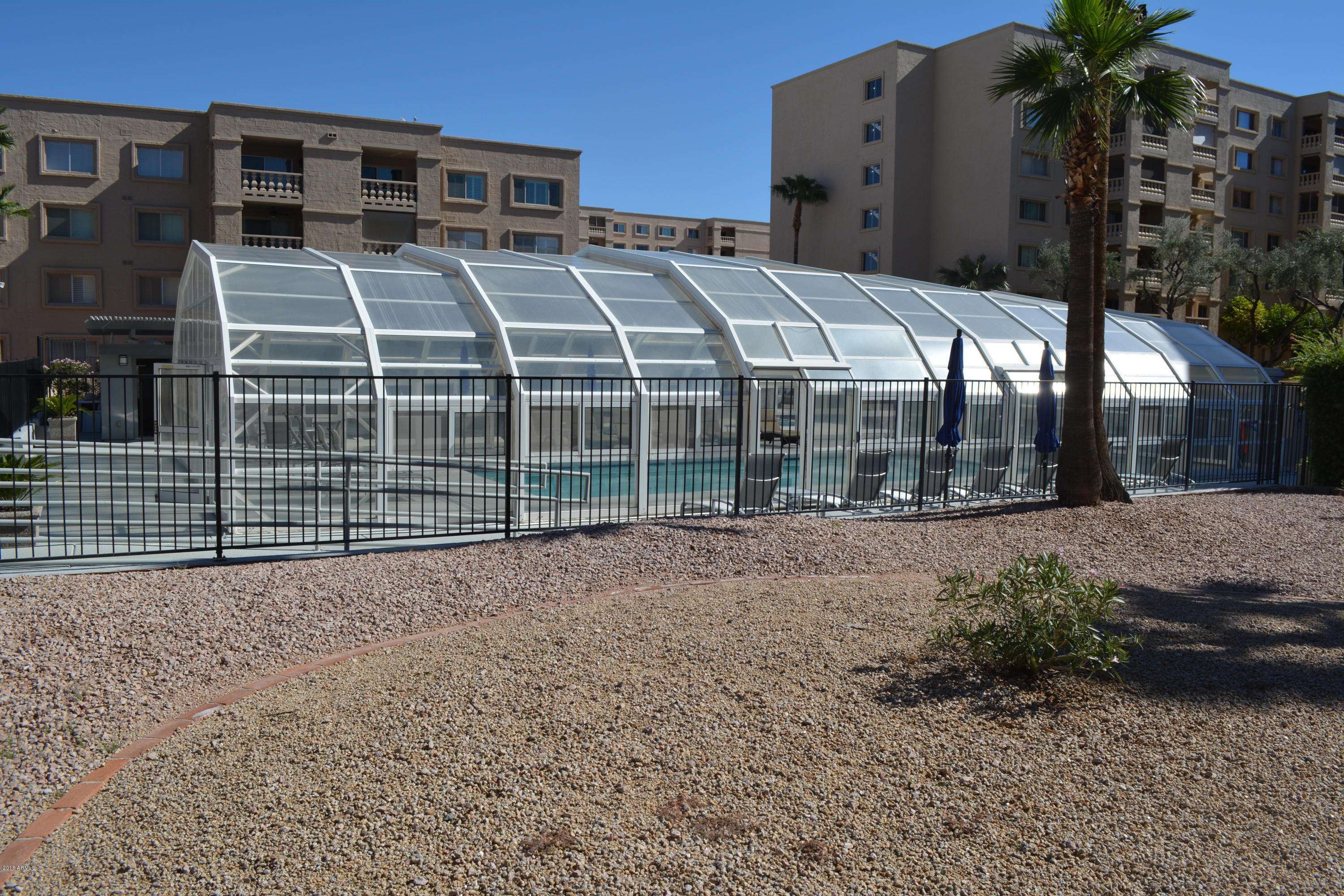 7870 East Camelback Road, Unit 412 Scottsdale, AZ 85251 - Photo 11 of 15 a view of a house with a yard and potted plants