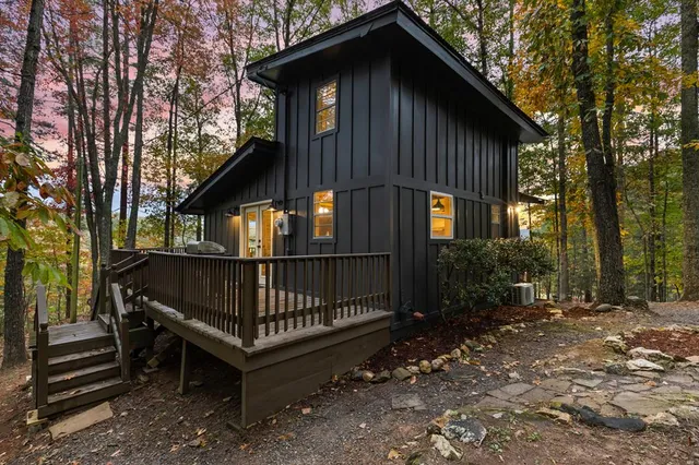 a view of a house with a yard and wooden fence