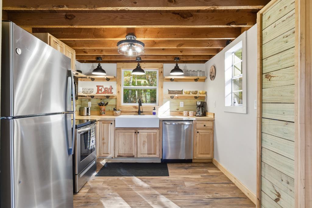 5240 Squirrel Hunting Road Blairsville, GA 30512 - Photo 12 of 40 a kitchen with stainless steel appliances a refrigerator and white cabinets