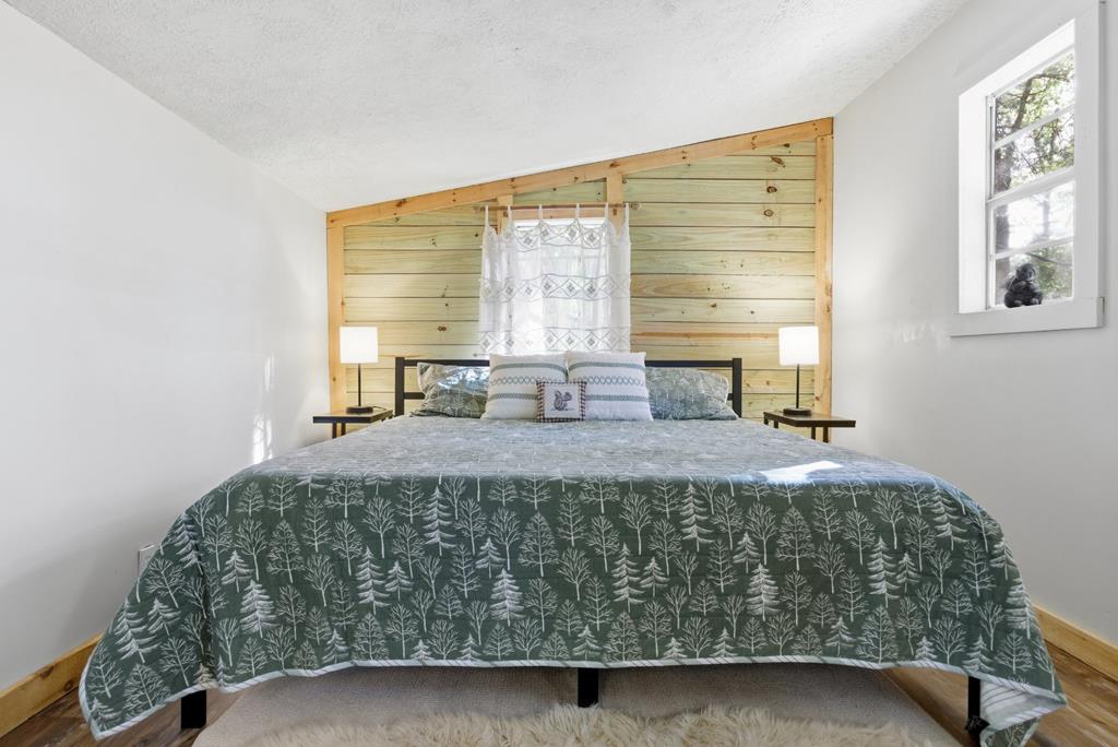 5240 Squirrel Hunting Road Blairsville, GA 30512 - Photo 16 of 40 a bed sitting in a bedroom next to a window