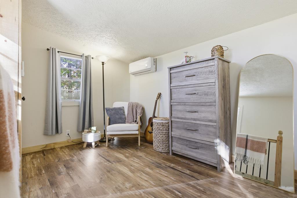 5240 Squirrel Hunting Road Blairsville, GA 30512 - Photo 17 of 40 a view of a bedroom with furniture and wooden floor