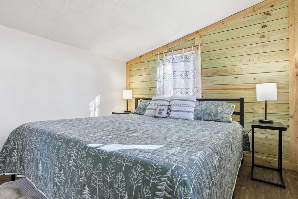 5240 Squirrel Hunting Road Blairsville, GA 30512 - Photo 20 of 40 a large bed sitting in a bedroom next to a window