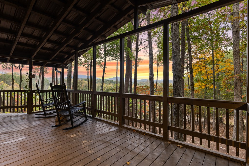 5240 Squirrel Hunting Road Blairsville, GA 30512 - Photo 31 of 40 a view of a balcony with chairs and wooden floor