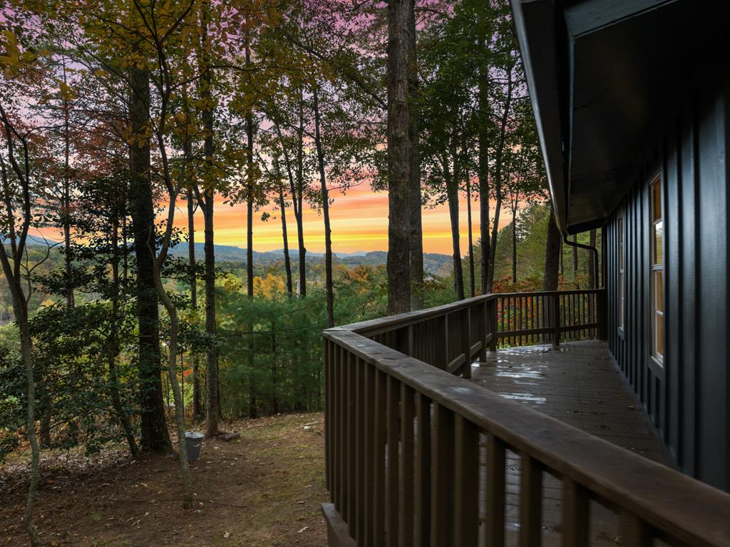 5240 Squirrel Hunting Road Blairsville, GA 30512 - Photo 38 of 40 a view of balcony with two trees and wooden fence
