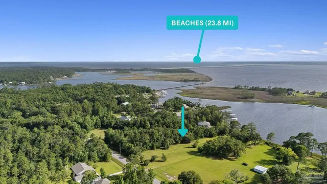 an aerial view of a beach with a yard and lake view