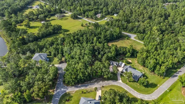 an aerial view of residential house with outdoor space and swimming pool