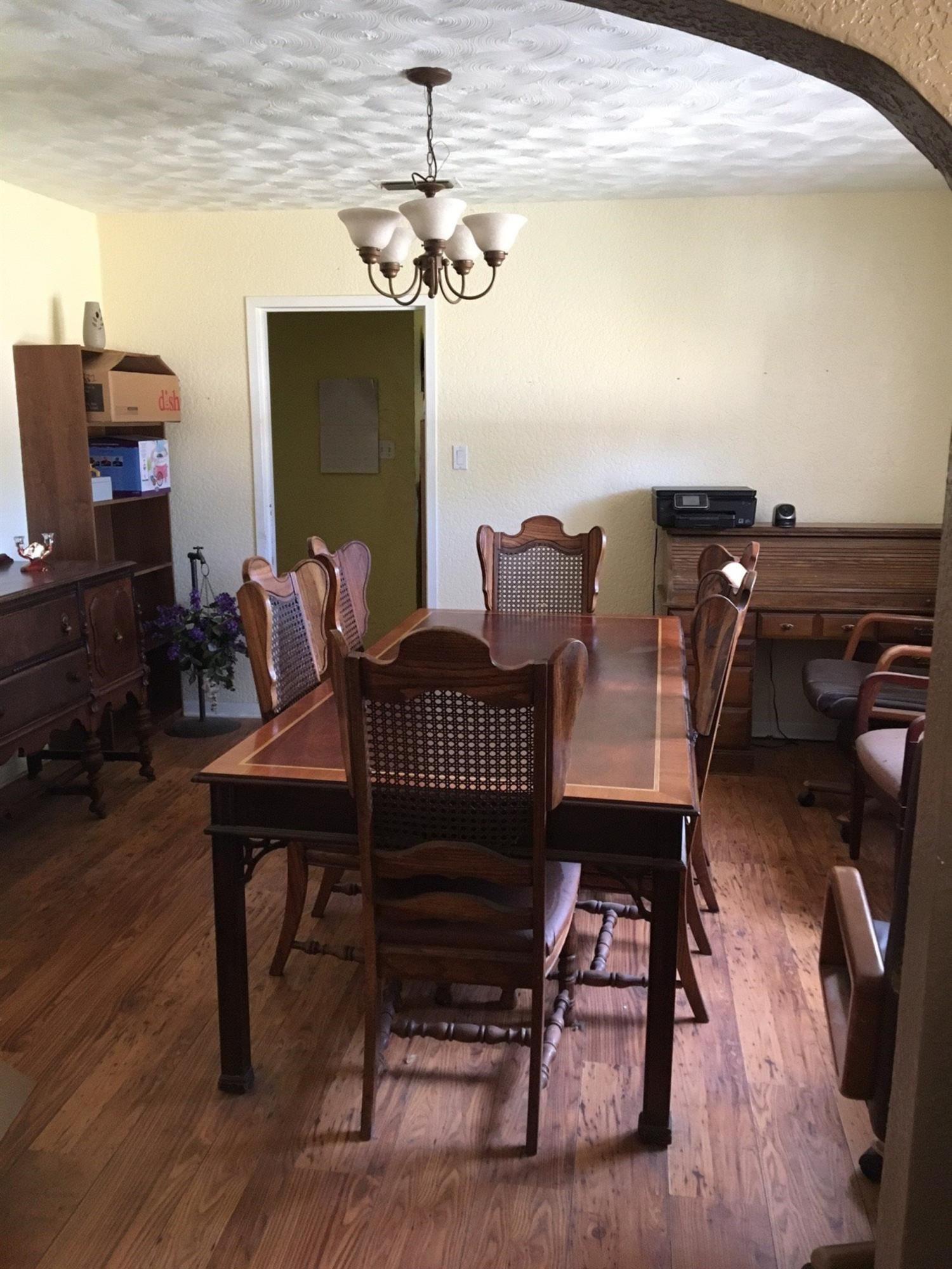 1420 Tilford Street Ralls, TX 79357 - Photo 4 of 7 a view of a dining room with furniture wooden floor and chandelier