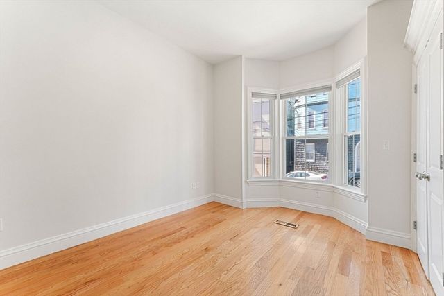 a bedroom with a bed and a potted plant
