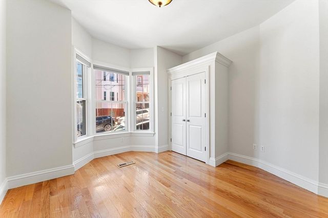 a view of a room with wooden floor and window