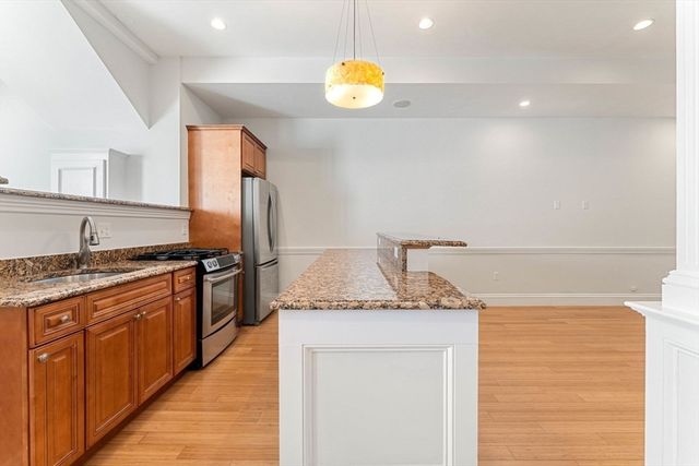 a kitchen with stainless steel appliances granite countertop a sink and a stove