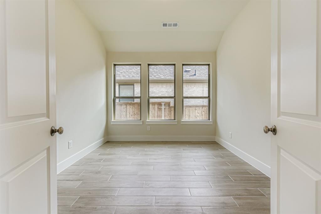 130 Pecan Lane Rhome, TX 76078 - Photo 13 of 28 Unfurnished room with wood tiled floors and vaulted ceiling