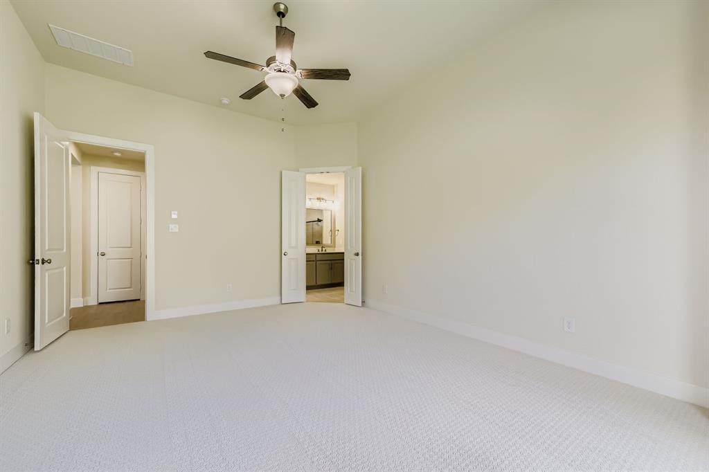 130 Pecan Lane Rhome, TX 76078 - Photo 15 of 28 Unfurnished bedroom with light carpet, ensuite bath, and ceiling fan