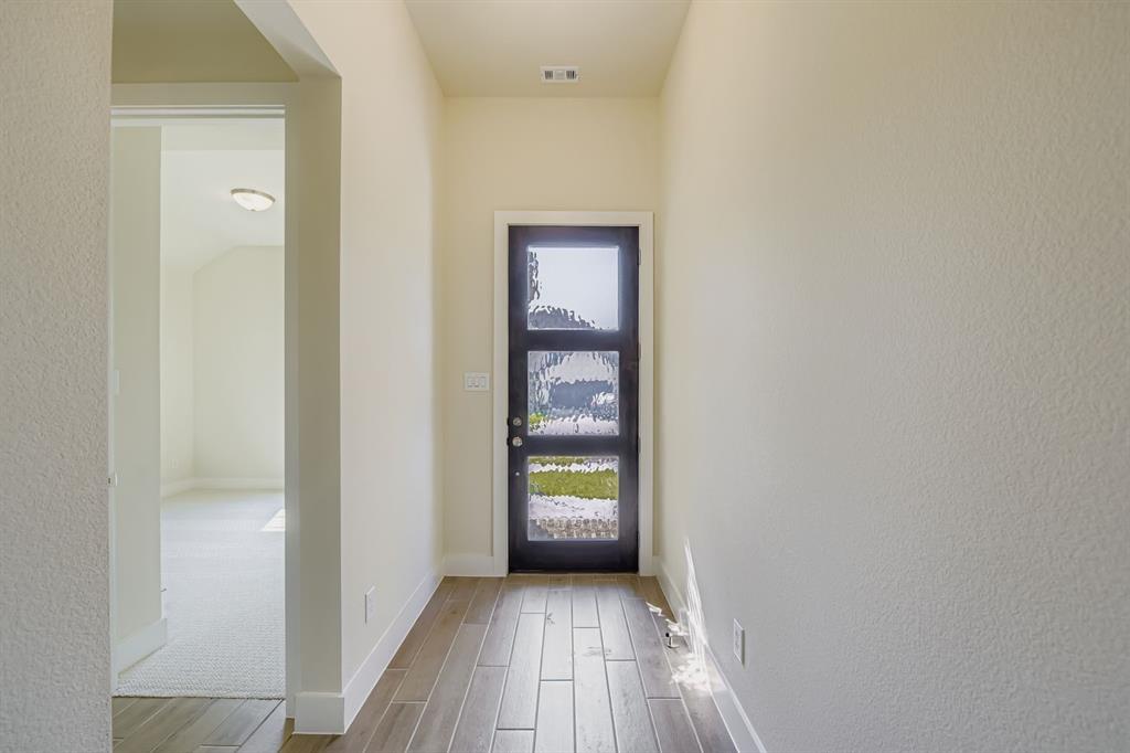 130 Pecan Lane Rhome, TX 76078 - Photo 4 of 28 Entryway featuring wood finished floors and a textured wall