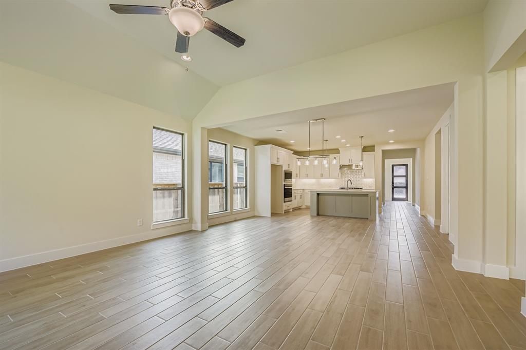 130 Pecan Lane Rhome, TX 76078 - Photo 7 of 28 Unfurnished living room featuring light wood finished floors, recessed lighting, ceiling fan, and lofted ceiling