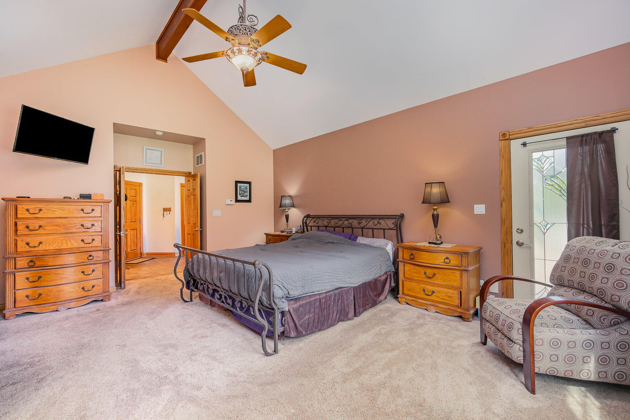 8855 East 93rd Avenue Crown Point, IN 46307 - Photo 18 of 41 a bedroom with a bed a dresser and a chandelier