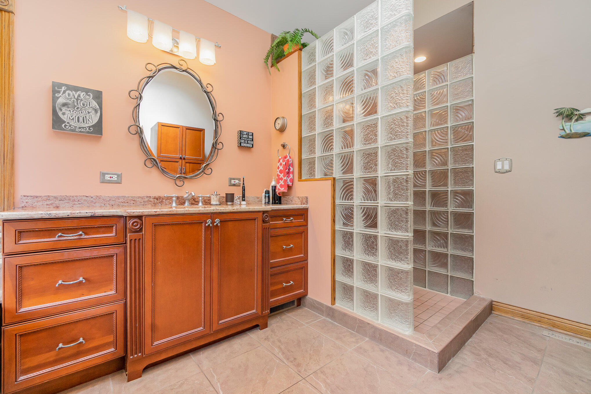 8855 East 93rd Avenue Crown Point, IN 46307 - Photo 21 of 41 a bathroom with a granite countertop sink a mirror a vanity and a shower