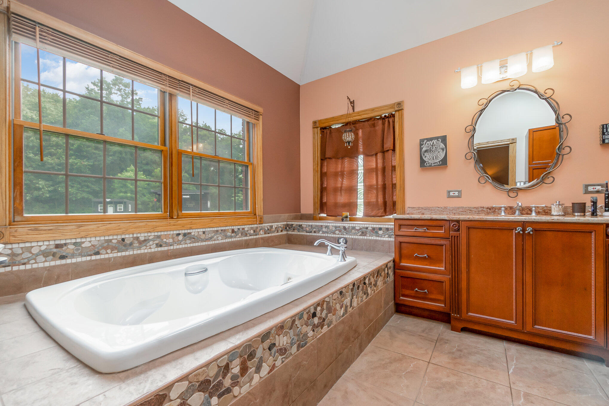 8855 East 93rd Avenue Crown Point, IN 46307 - Photo 22 of 41 a spacious bathroom with a tub a double vanity sink and a large mirror