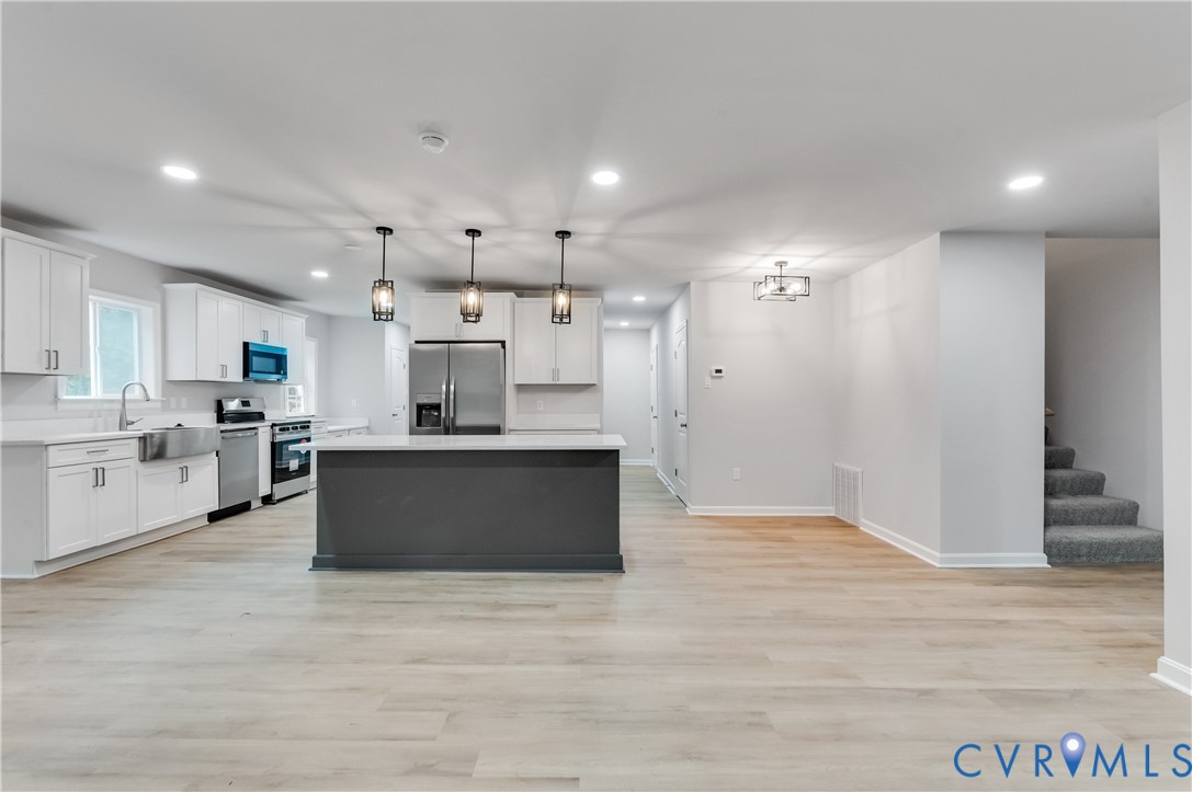 7906 Battlefield Park Road Henrico, VA 23231 - Photo 11 of 42 a large kitchen with a large counter top a sink stainless steel appliances and cabinets