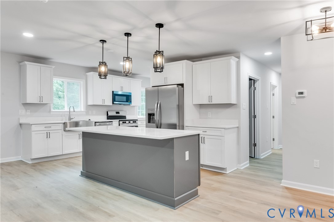 7906 Battlefield Park Road Henrico, VA 23231 - Photo 13 of 42 a kitchen with kitchen island white cabinets and refrigerator