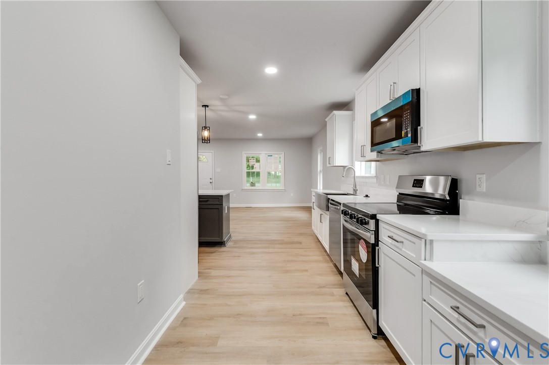 7906 Battlefield Park Road Henrico, VA 23231 - Photo 18 of 42 a large kitchen with stainless steel appliances granite countertop a stove and a sink