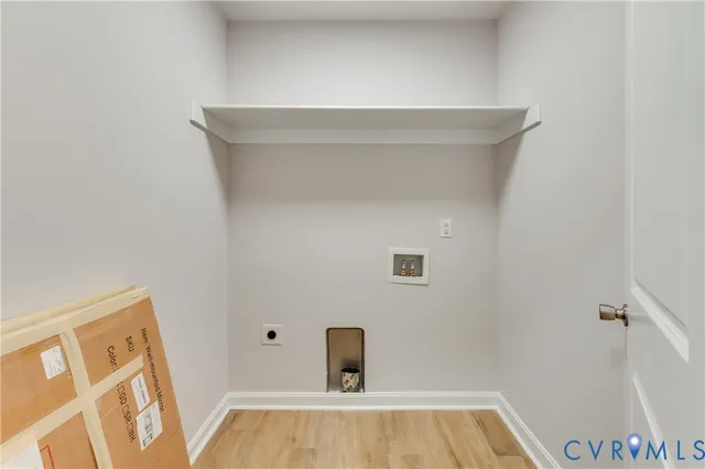 a spacious bedroom with a bed and a potted plant