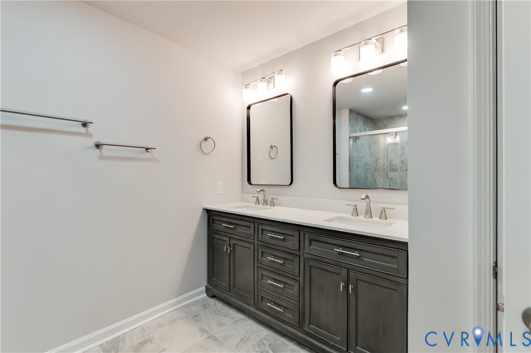 7906 Battlefield Park Road Henrico, VA 23231 - Photo 26 of 42 a bathroom with a double vanity sink and a mirror