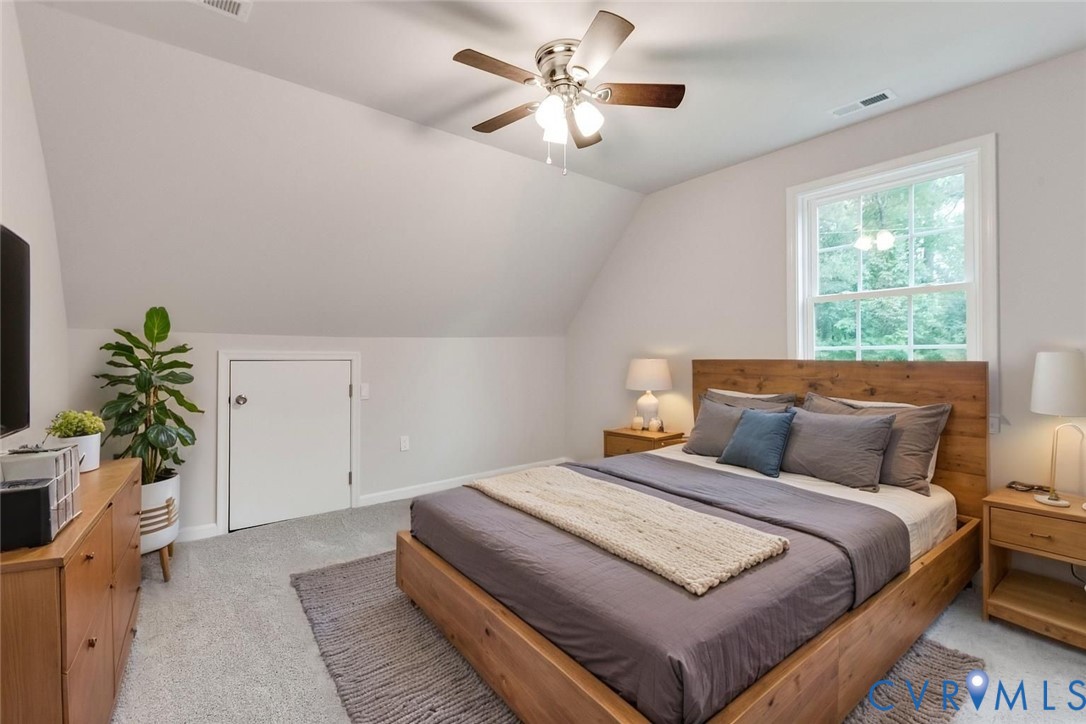 7906 Battlefield Park Road Henrico, VA 23231 - Photo 32 of 42 a bedroom with a large bed and a chandelier