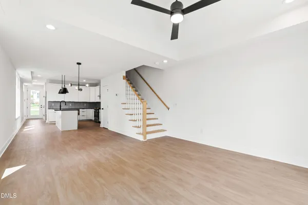a view of empty room with wooden floor and windows