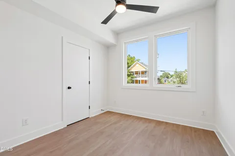a view of a hallway with wooden floor and entryway