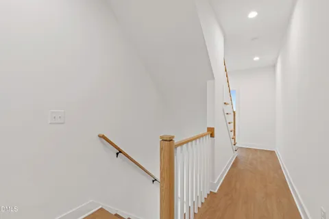 a view of a room with wooden floor and a bathroom