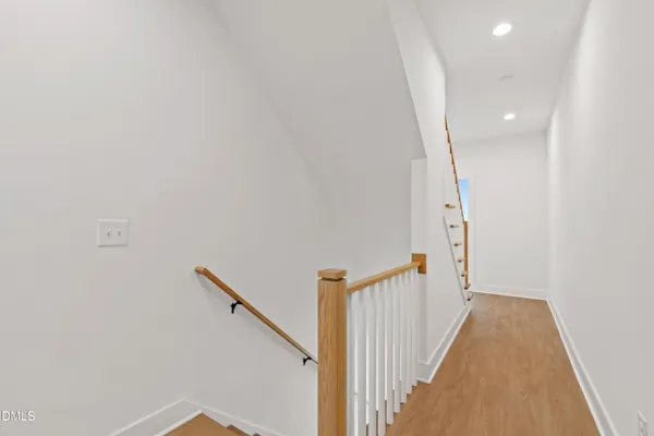 a view of a room with wooden floor and a bathroom