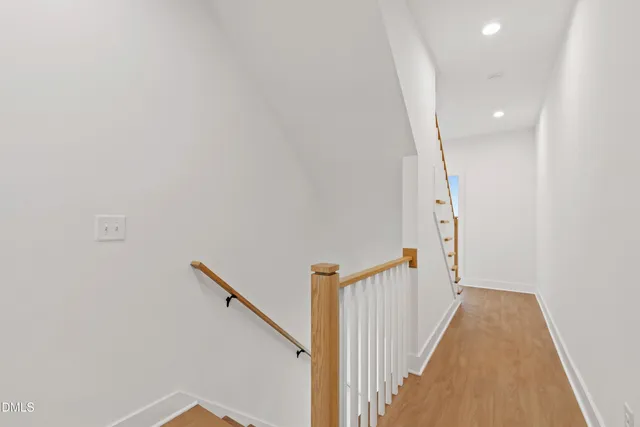 a view of a room with wooden floor and a bathroom