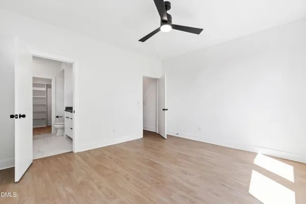 a view of walk in closet with empty racks