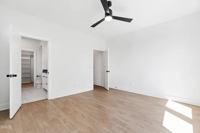 a view of walk in closet with empty racks