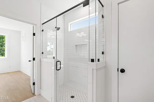 wooden floor in an empty room with a ceiling fan