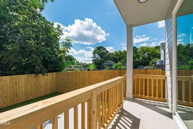 a view of a backyard with wooden fence