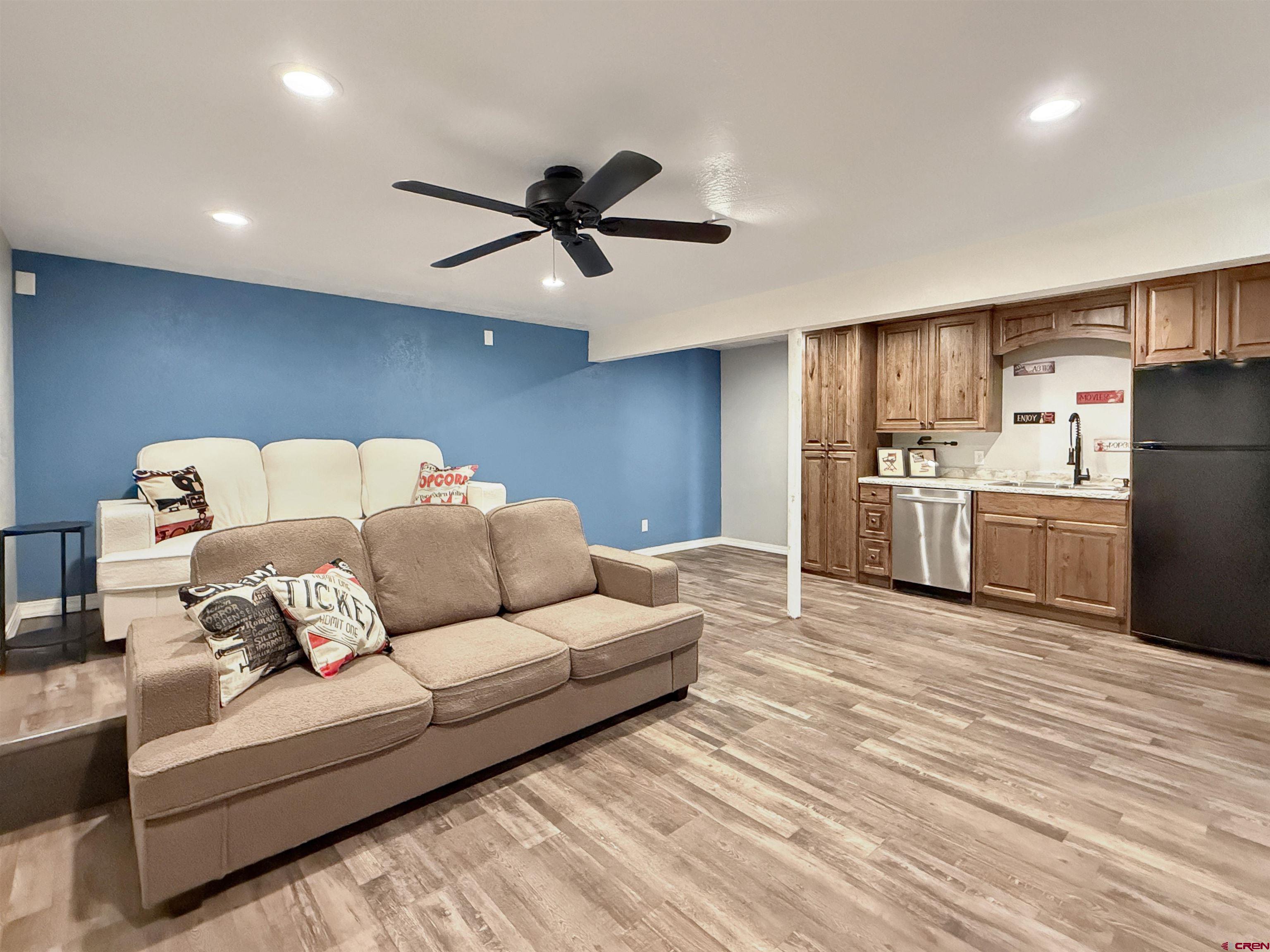 a living room with furniture and kitchen view