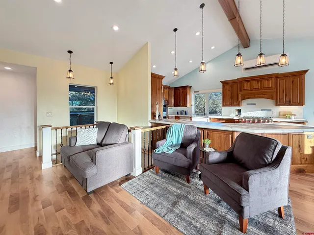 a living room with fireplace furniture and a wooden floor