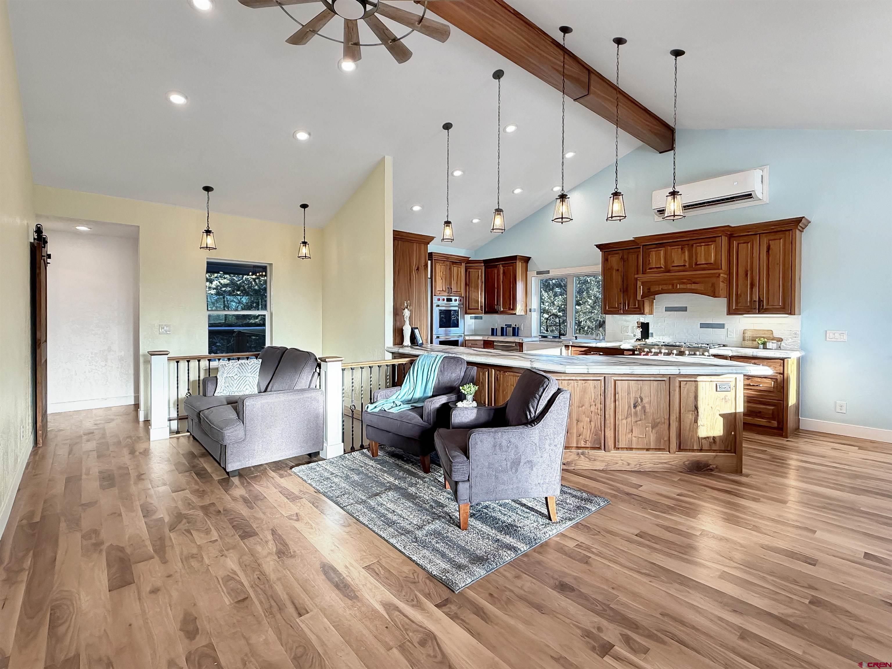 27425 Rd P.7 Dolores, CO 81323 - Photo 14 of 45 a living room with stainless steel appliances kitchen island a wooden floor and a chandelier