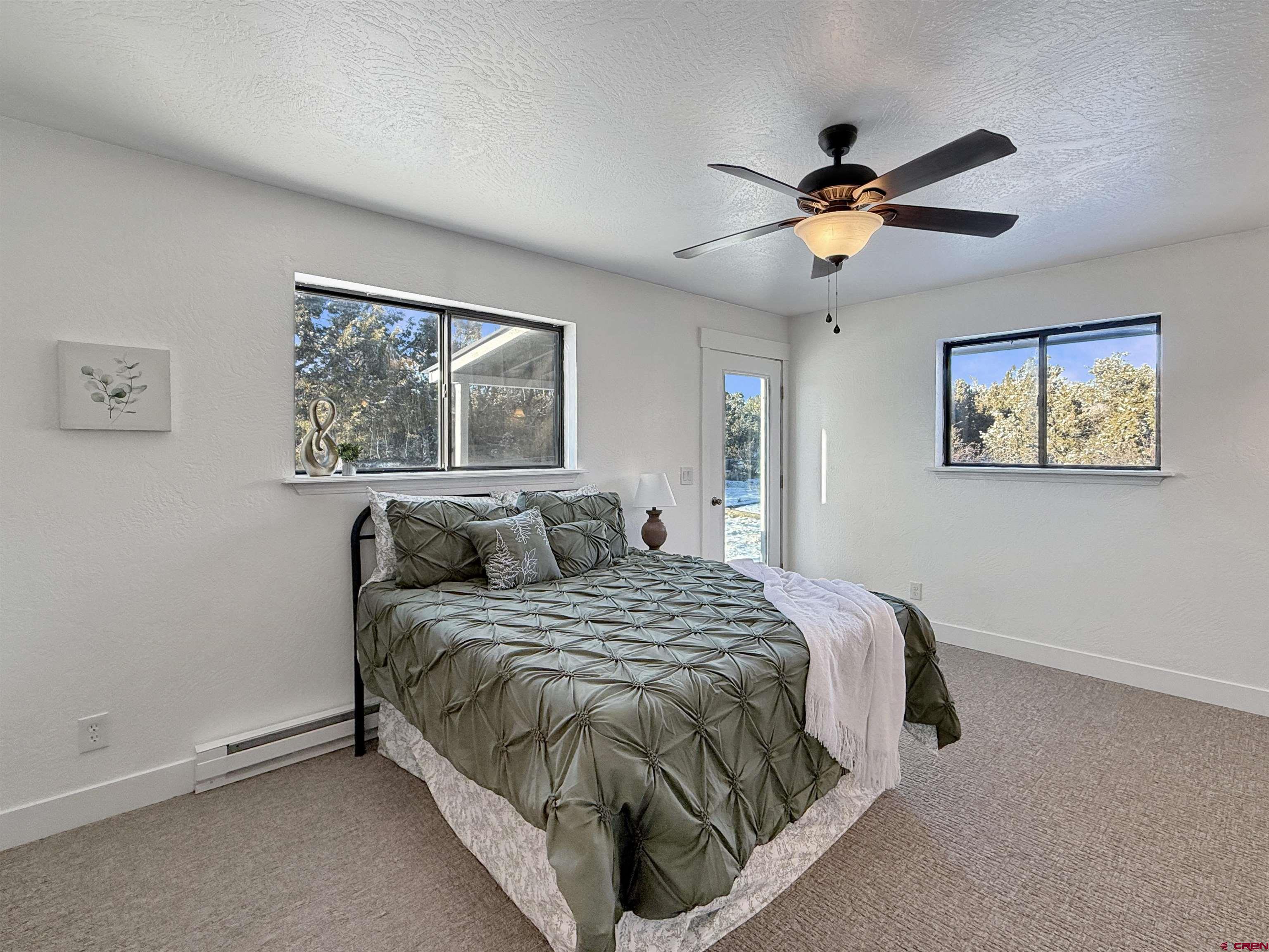 27425 Rd P.7 Dolores, CO 81323 - Photo 17 of 45 a bedroom with a bed and a chandelier