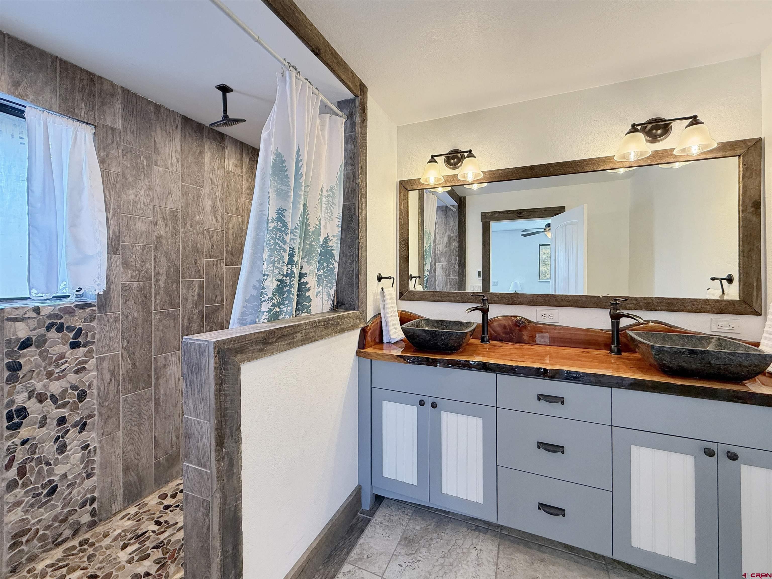 27425 Rd P.7 Dolores, CO 81323 - Photo 19 of 45 a bathroom with a double vanity sink and mirror