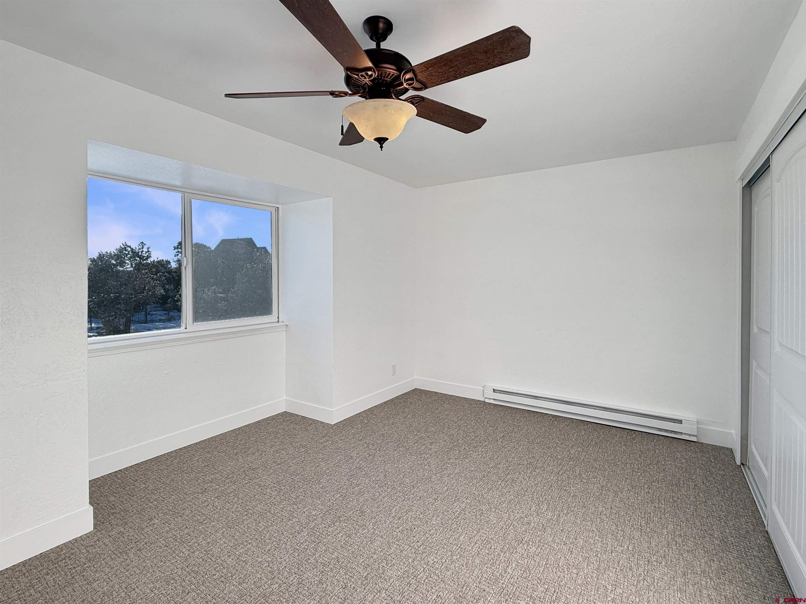 27425 Rd P.7 Dolores, CO 81323 - Photo 21 of 45 an empty room with a window and a fan