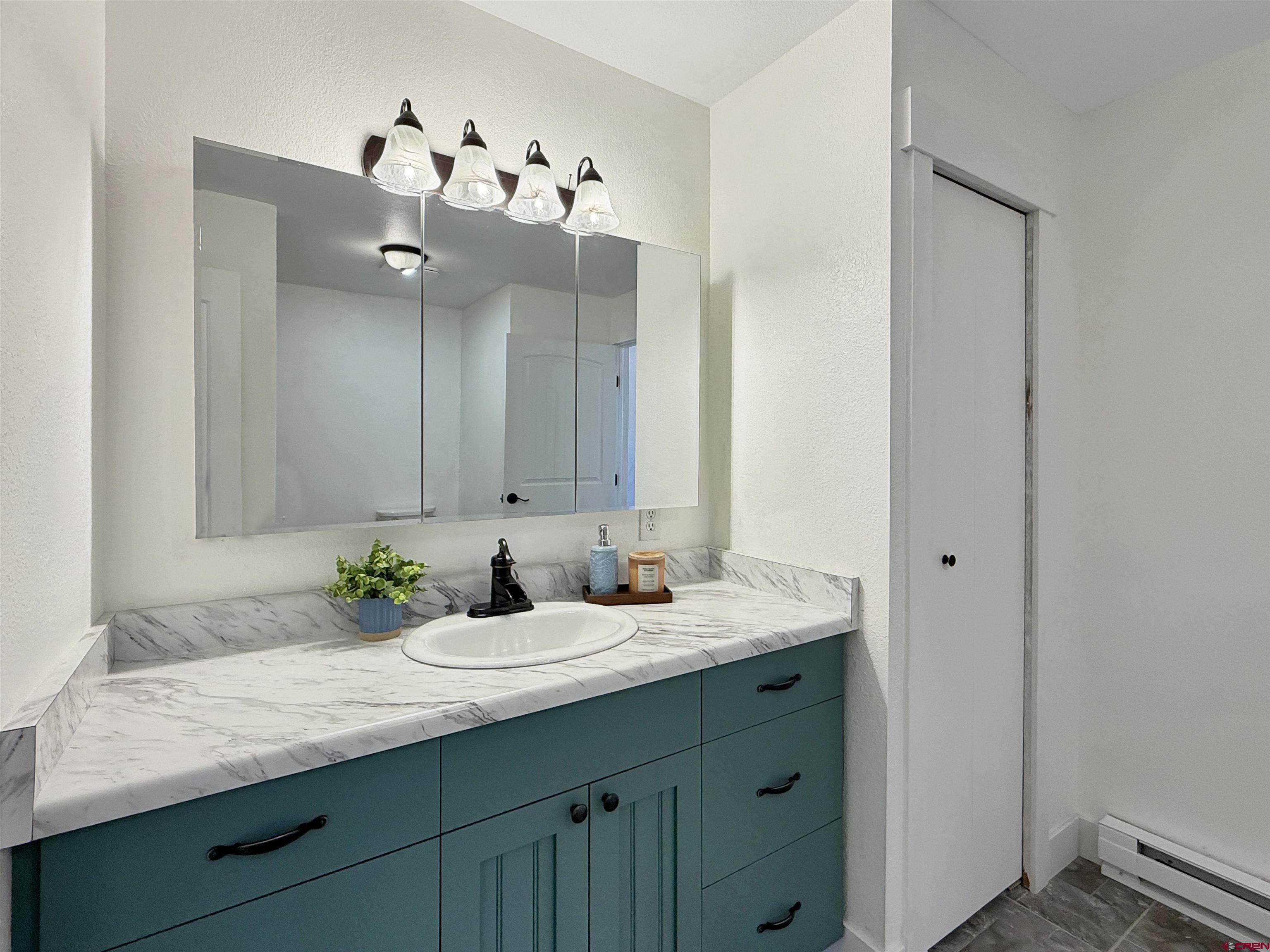 27425 Rd P.7 Dolores, CO 81323 - Photo 22 of 45 a bathroom with a granite countertop sink and a mirror
